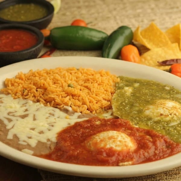 El Cerro Grande's Huevos Rancheros with red and green sauce, rice, and refried beans.